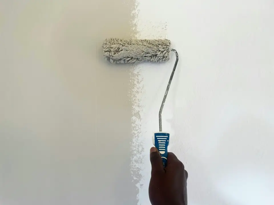 A paint roller on a white wall